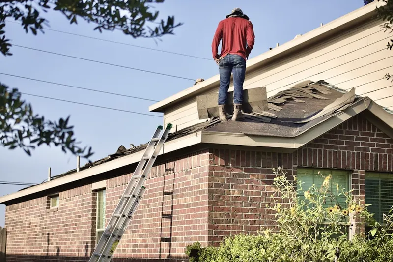 Professional roofer working on a residential roof in Lancaster Hills